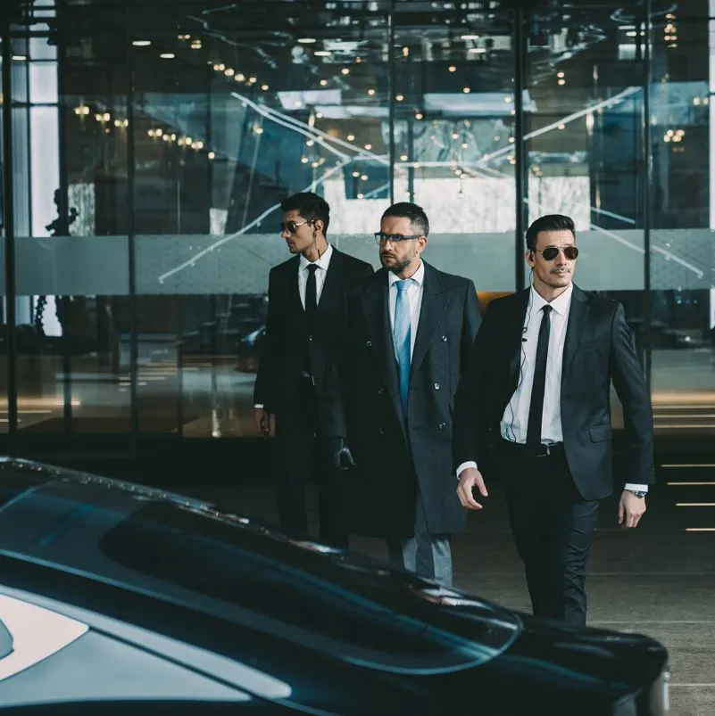 Close protection bodyguards with client