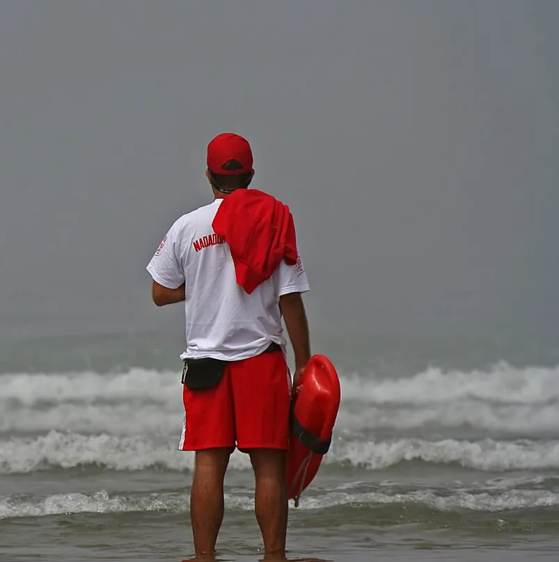 Lifeguard looking at the waves on a beach