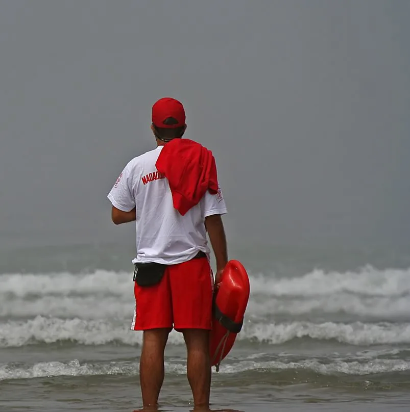 Lifeguard Looking at the Waves on the Beach