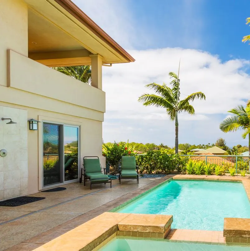 Luxury home with a pool area and palm trees