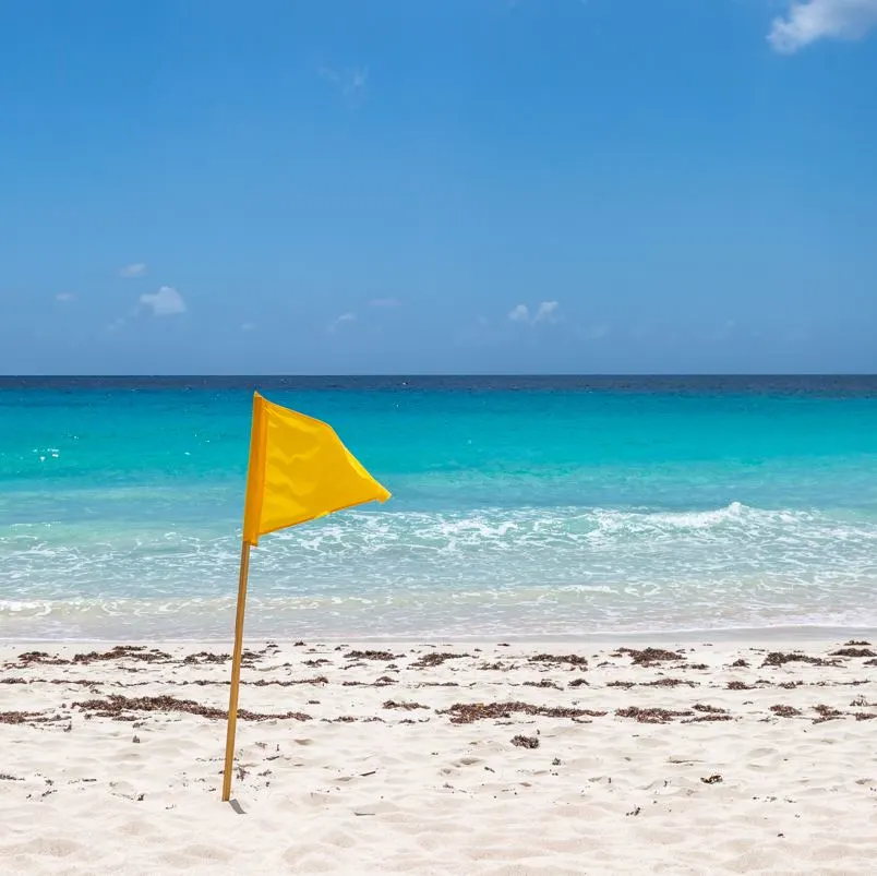 Yellow beach flag warning swimmers of dangerous conditions