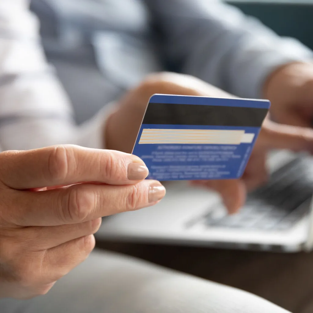 Person using credit card to book online