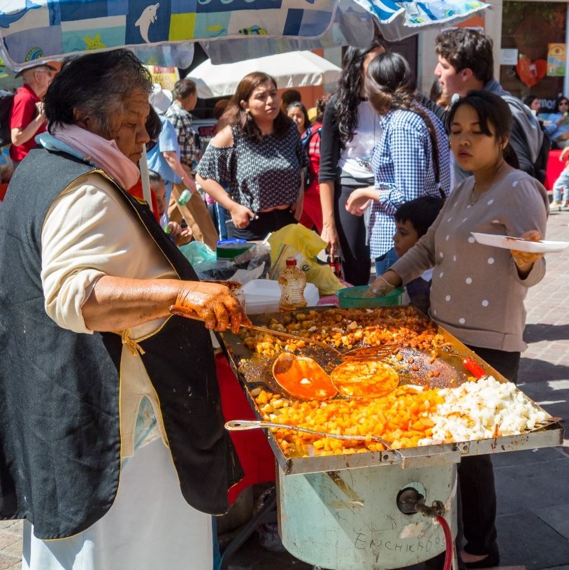 Food vendor preparing street food.