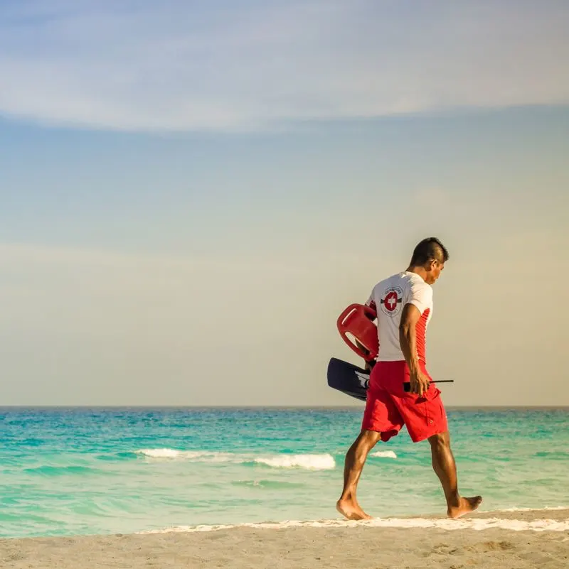 Lifeguard walking on a beach in Los Cabos