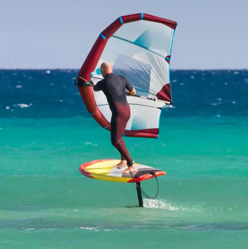 Man On A Powered Paddle Board Kite Surfing