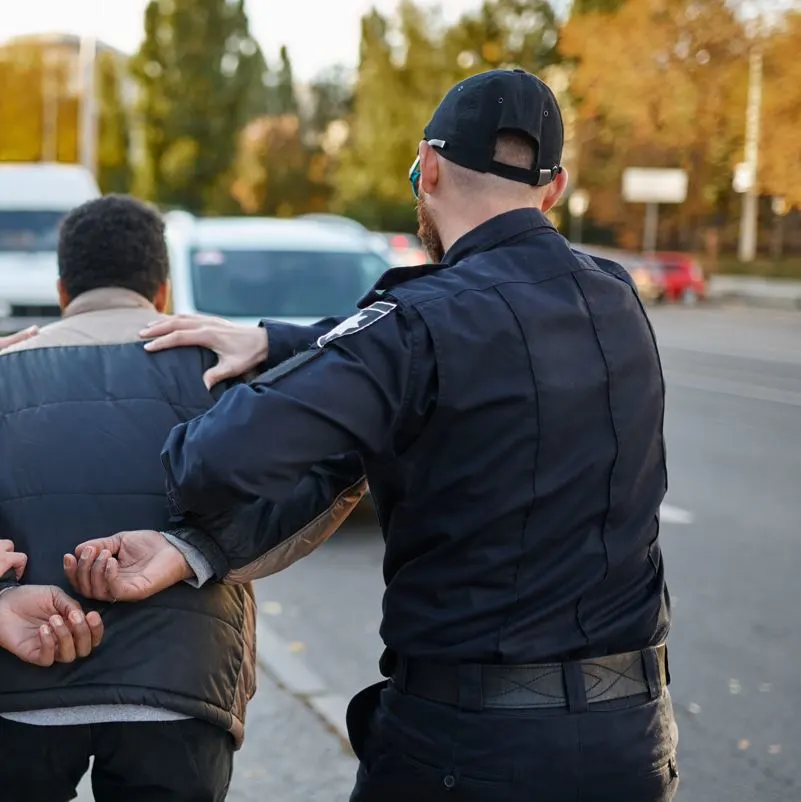 Person Being Escorted In Handcuffs By Police