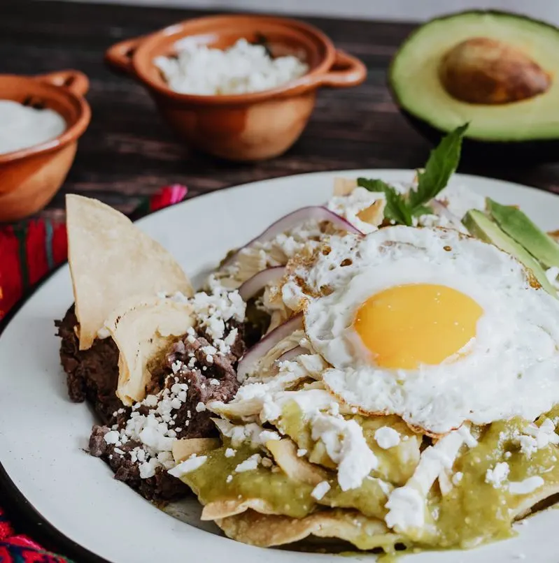 Plate of green chilaquiles served for breakfast