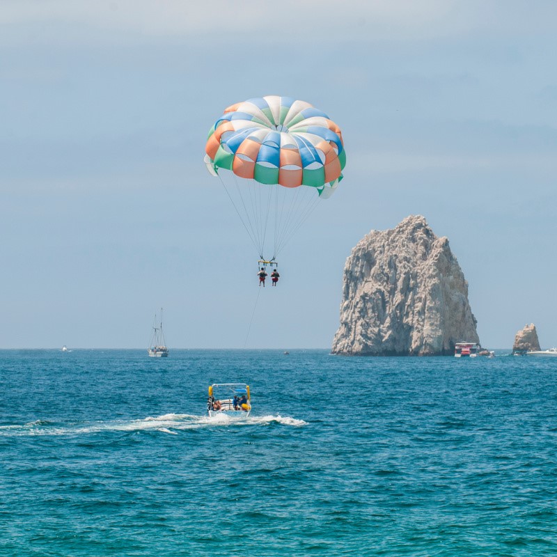Two People Parasailing Near the Arch in Cabo San Lucas, Mexico