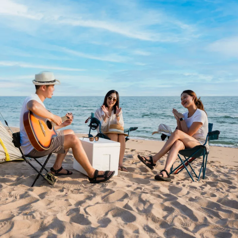 group of friends camping on the beach