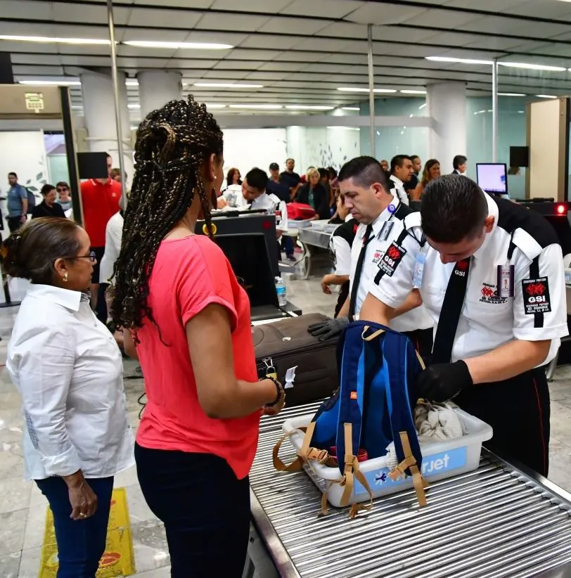 Visitors clearing security at an airport in Mexico