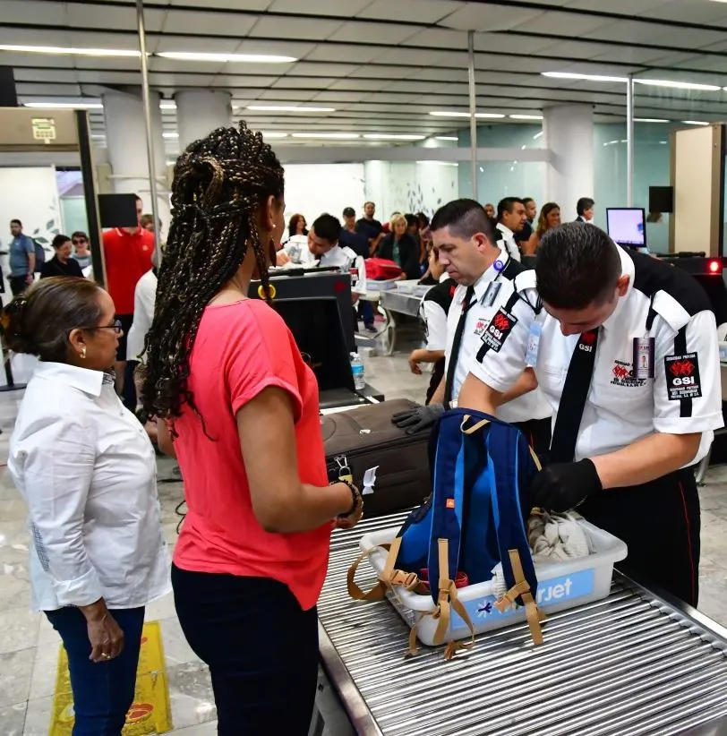 Security agents checking bags at airport