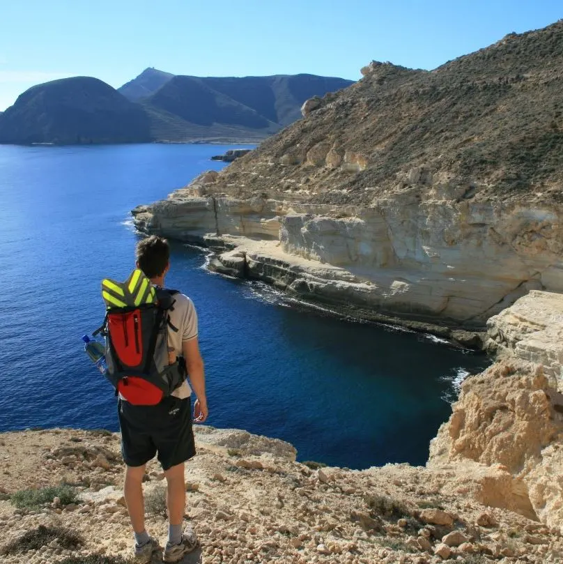 A hiker enjoying a scenic view of the ocean