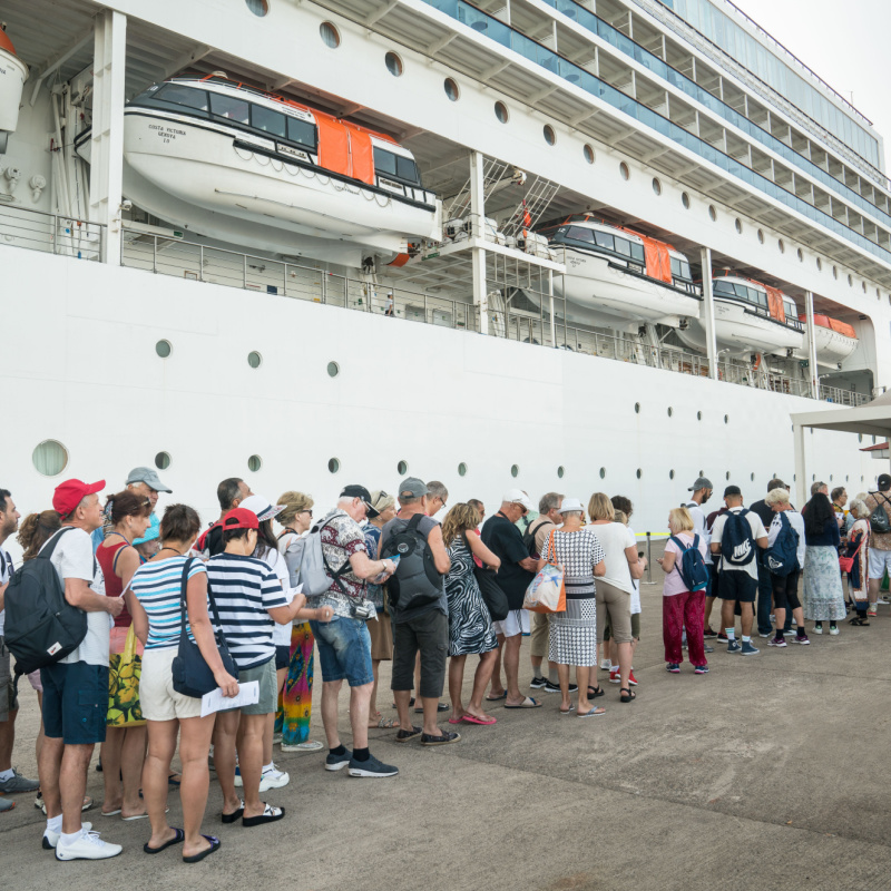 People Waiting In line To Board A Cruise