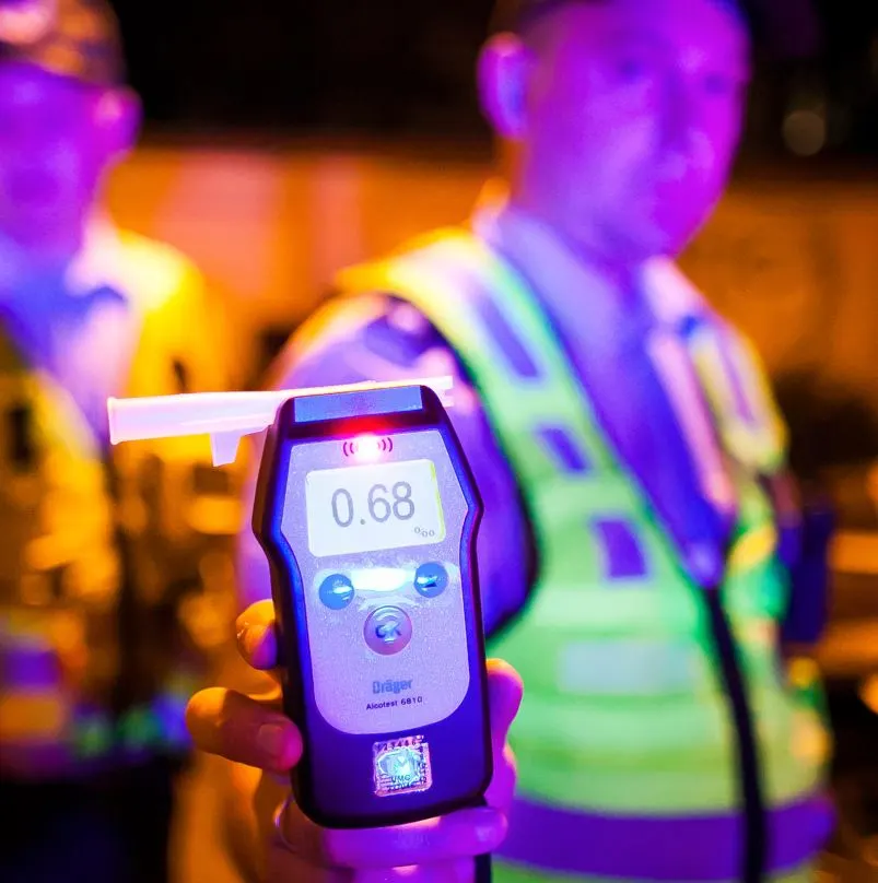 Police Officers With A Breathelizer Showing A Reading