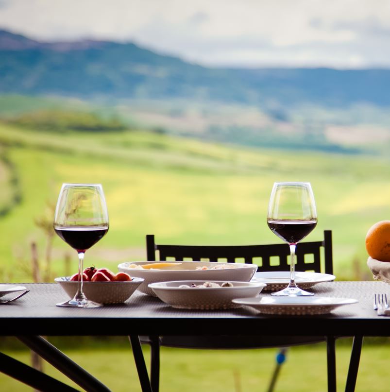 Table with wine glasses overlooking a large plain