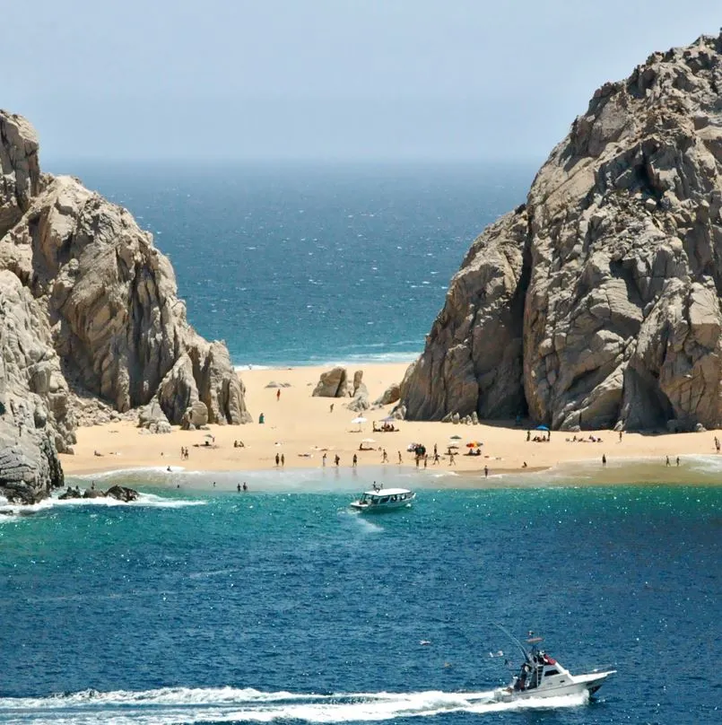 View of Lover's beach with many boats and people on the beach