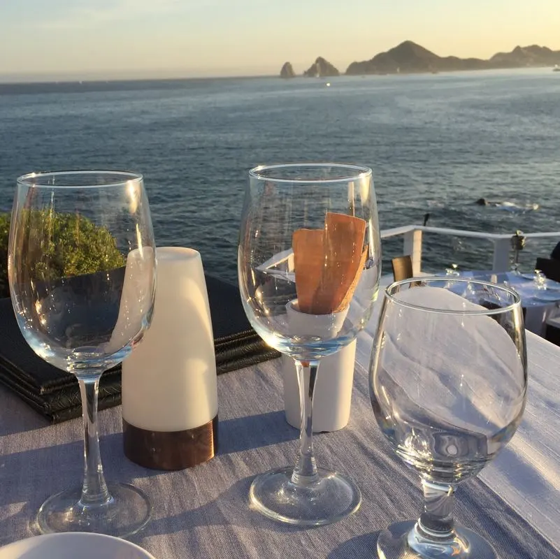 A picture of the famous sea arch in Cabo taken from a restaurant balcony across the bay