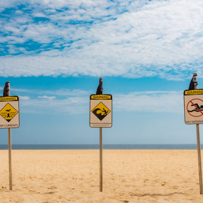 3 Warning Signs Set Up In A Cabo Beach