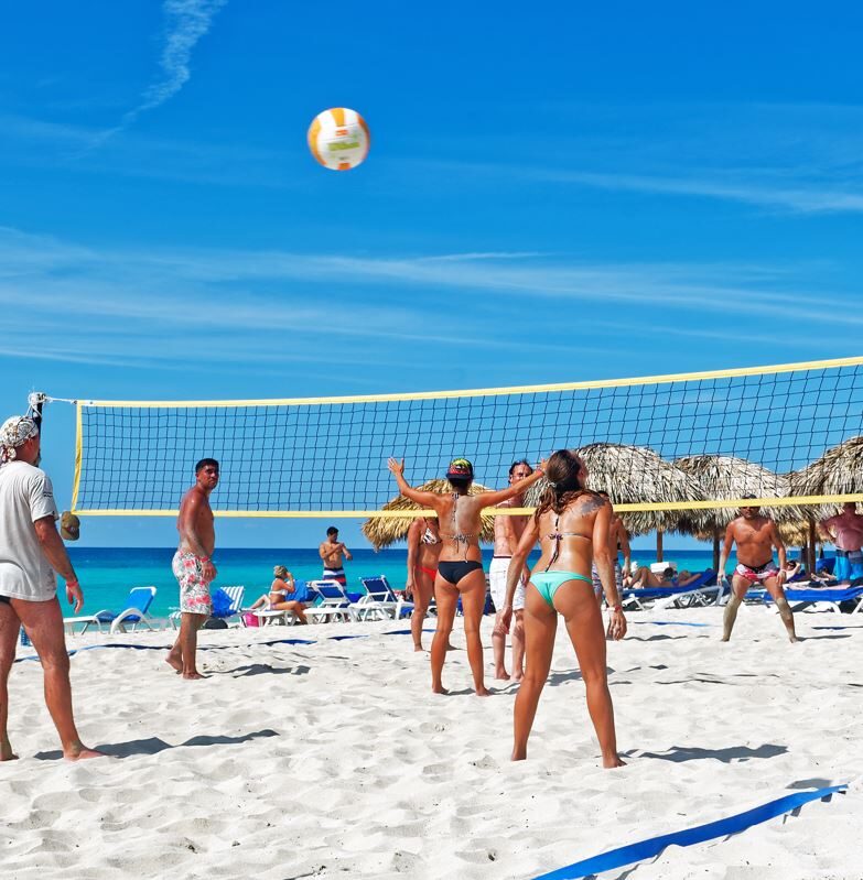 American Tourists Playing Beach Volleyball In Los Cabos