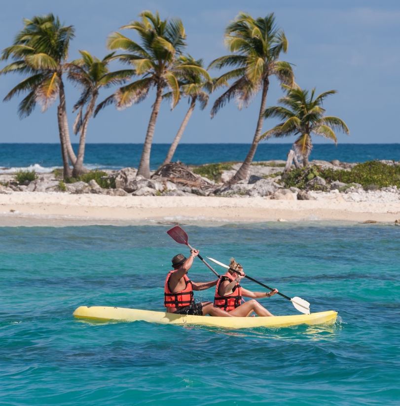 Tourists kayaking in the ocean