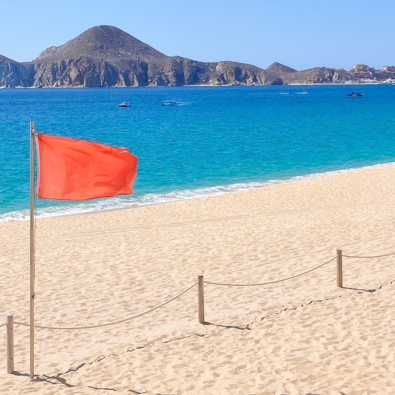 A red beach flag in los cabos