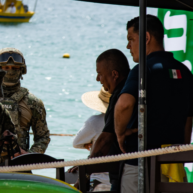 Police and Military Officers Talking to a Vendor on a Los Cabos Beach