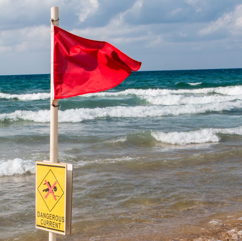 Red Flag On A Beach Indicating No Swimming