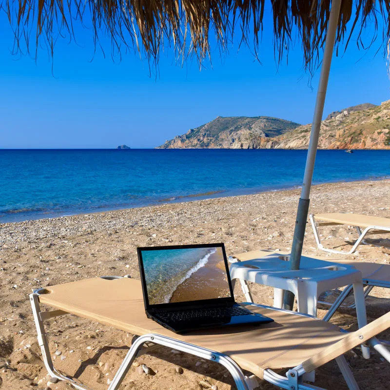 Laptop on a Lounge Chair on a Sandy Beach