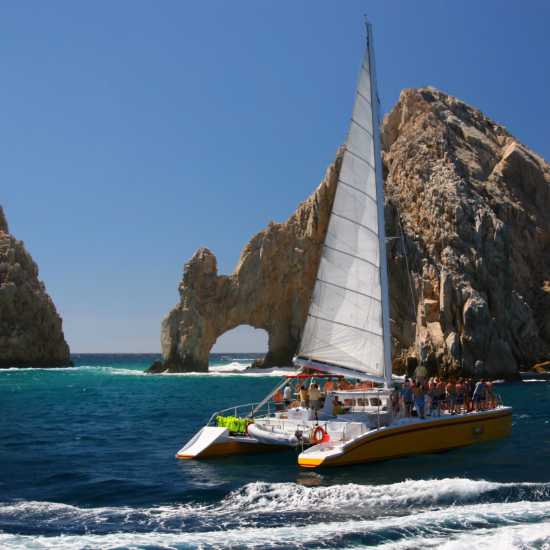 Tourists on a Luxury Catamaran in Front of the Famous Arch in Cabo San Lucas, Mexico