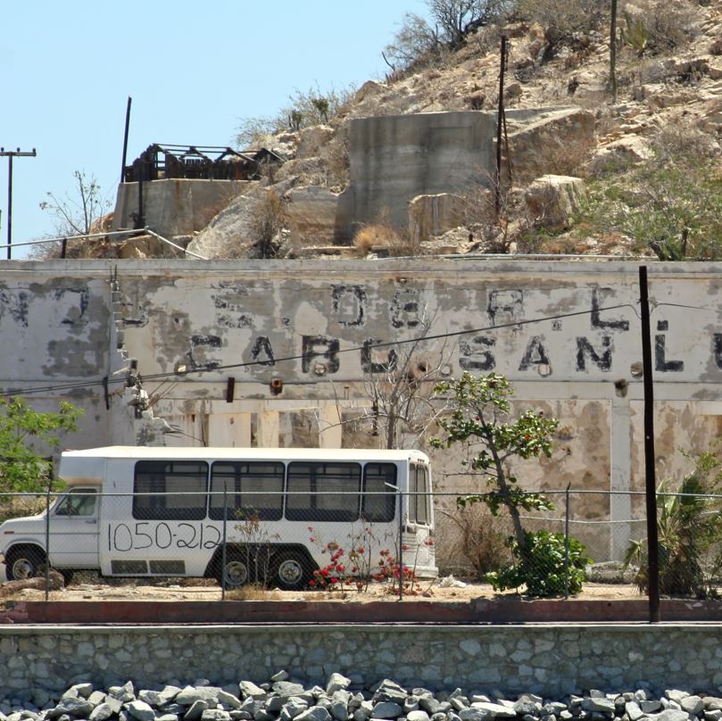 Bus Passing By A Worn Down Cabo Area