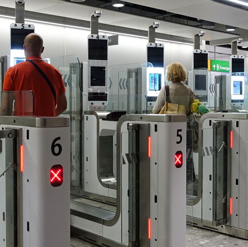 People At An Automatic Passport Checking Machine