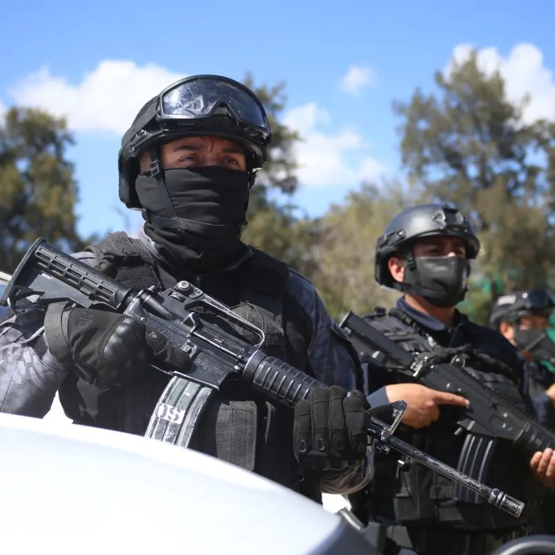 Police officers on guard with heavy duty weapons