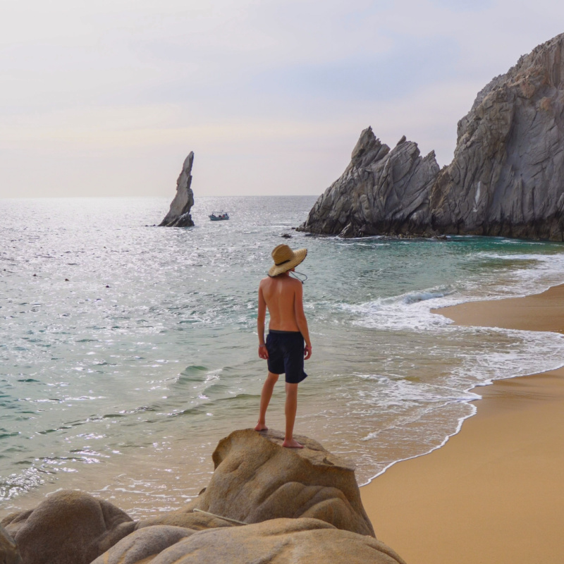 Man Staring Out Over Lover's Beach in Cabo San Lucas, Mexico