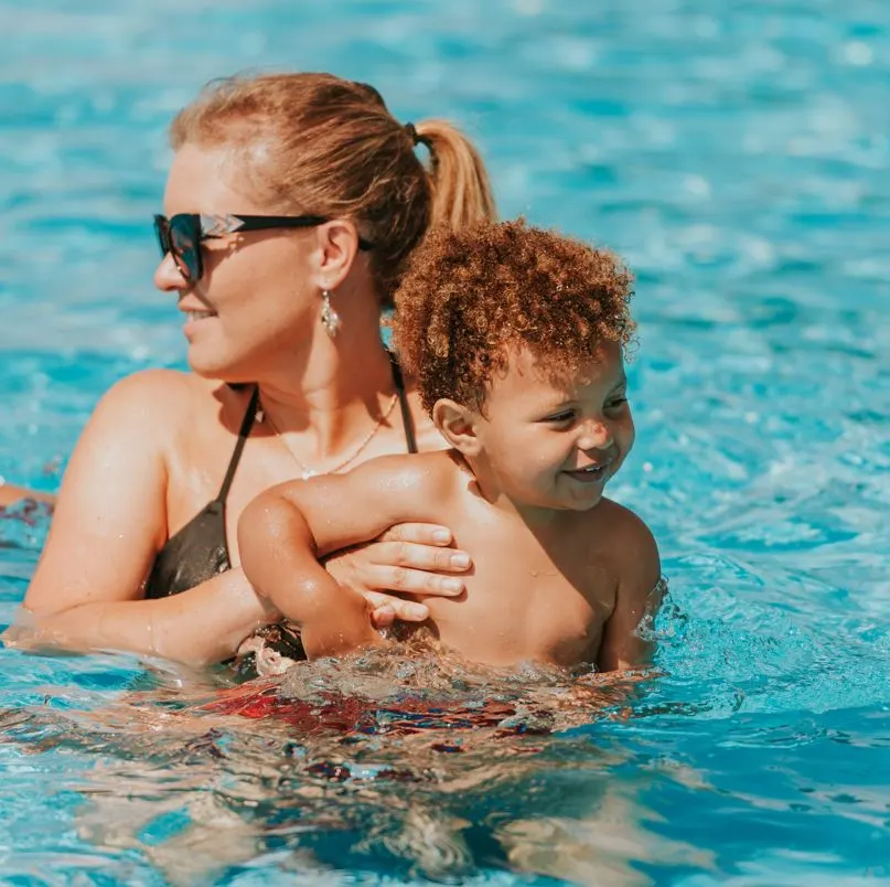 mom and baby playing at the pool