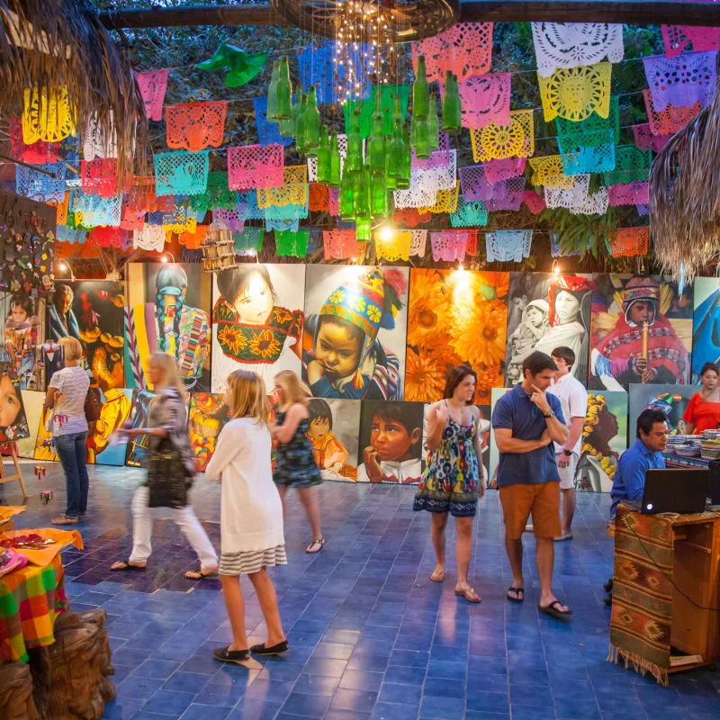 Travelers shopping at an art fair in Los Cabos