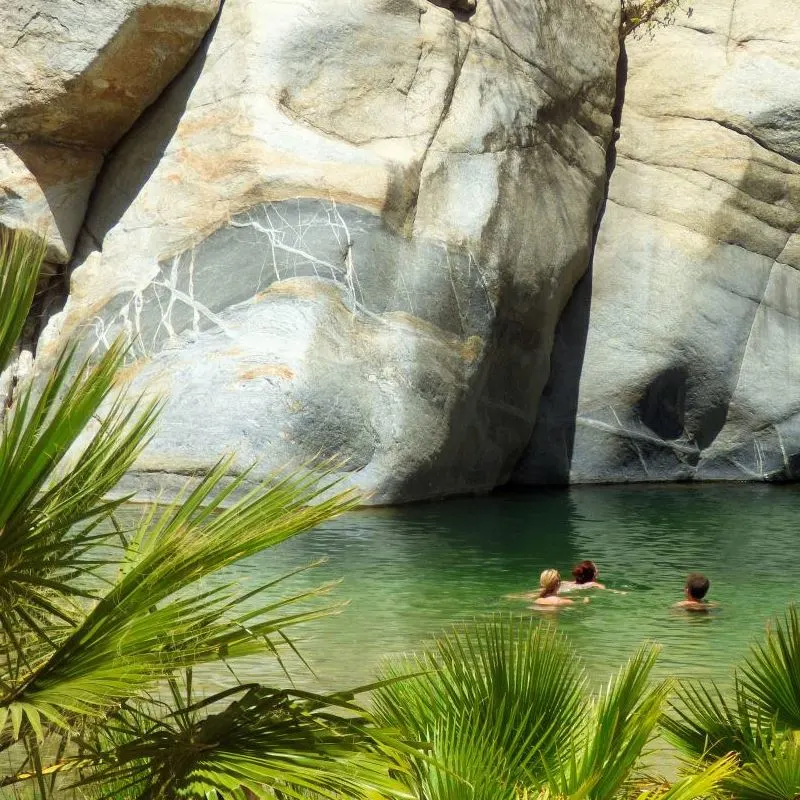 People swimming in a waterfall pool near Santiago