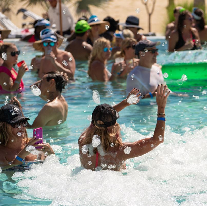 Tourists at a pool party at the hard rock hotel in Cabo