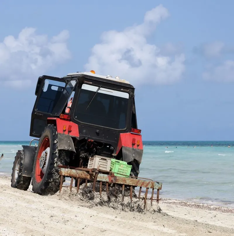 Tractor cleaning up the beach