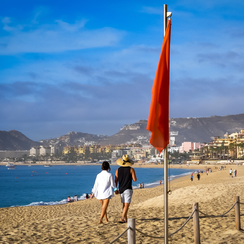 beachgoers on a red-flagged beach in cabo