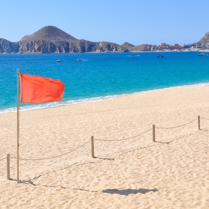 red flag on a beach in cabo