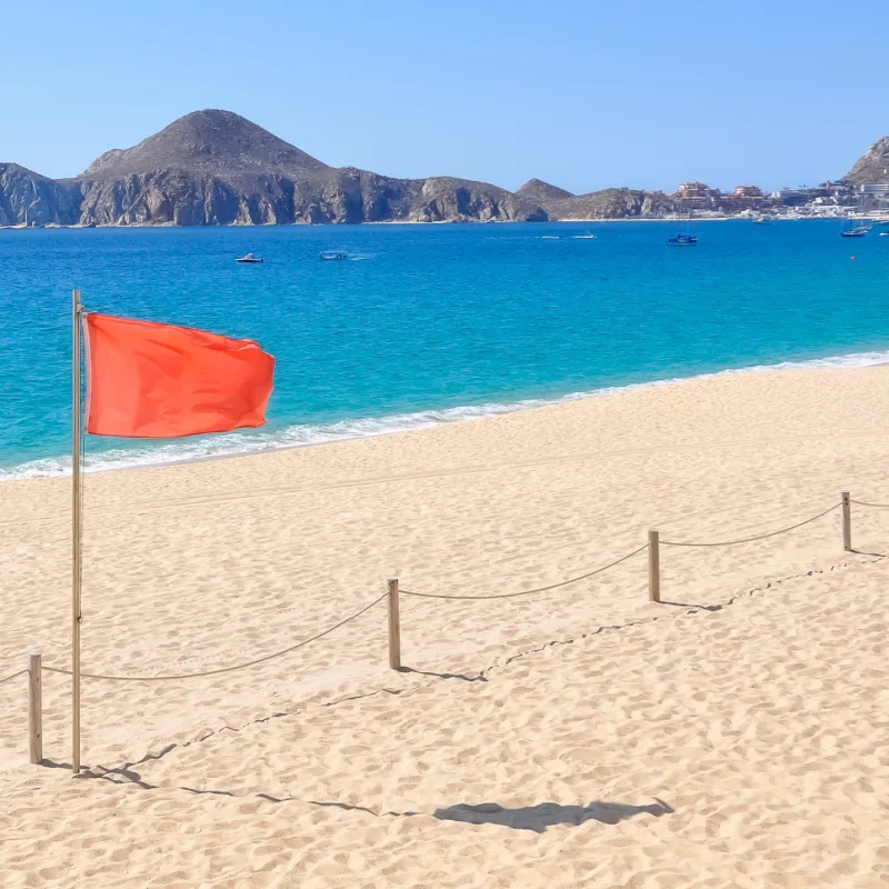 red flag on a beach in cabo