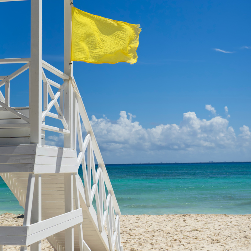 Yellow flag posted on a beach