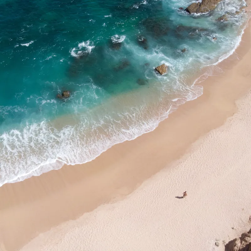 Aerial View of Chileno Beach in Los Cabos with One Person Walking on the Sand