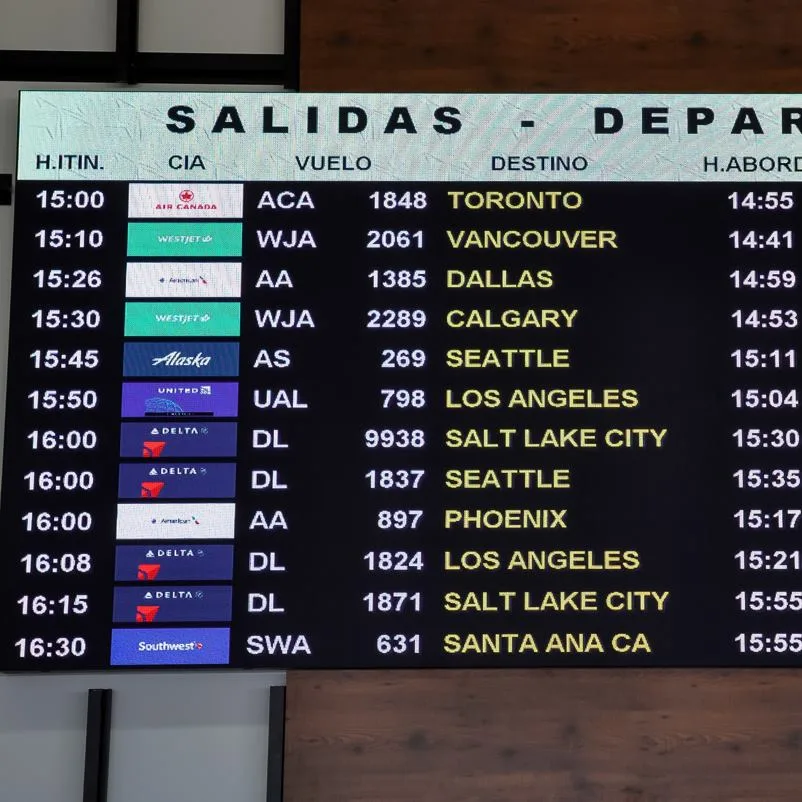 Cabo airport departure board with US and Canadian cities shown