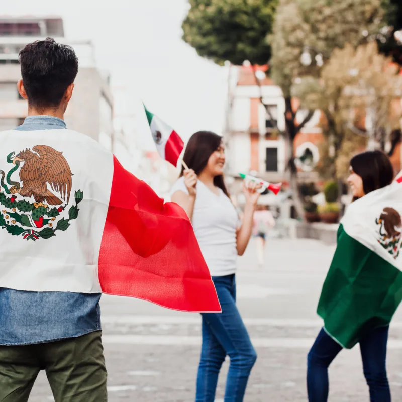 People celebrating Independence Day with Mexican flags