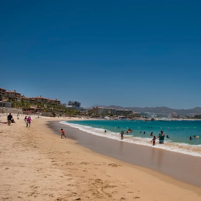 Tourists Enjoying Medano Beach in Cabo San Lucas, Mexico