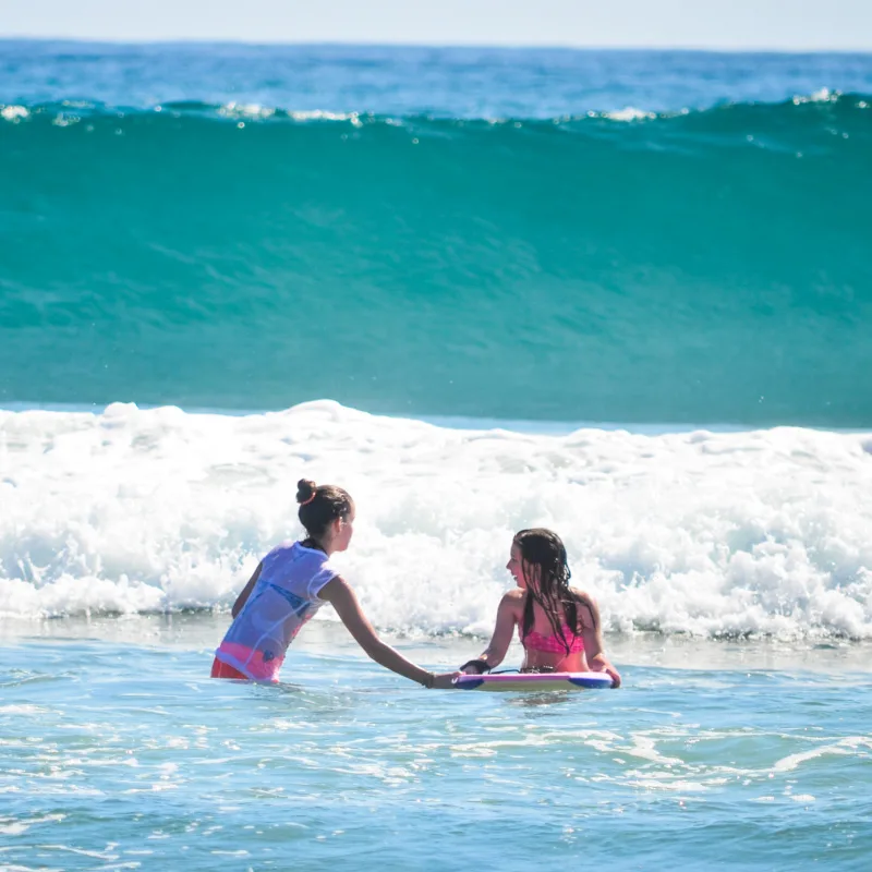 Two surfers in Los Cabos waiting for the perfect wave