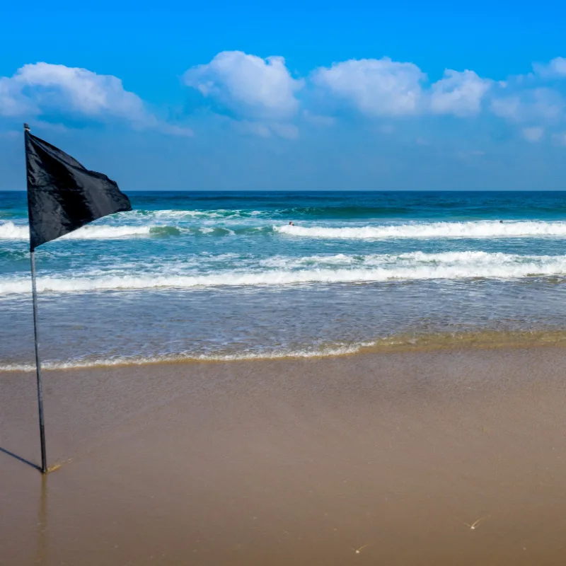 black flag on sandy beach
