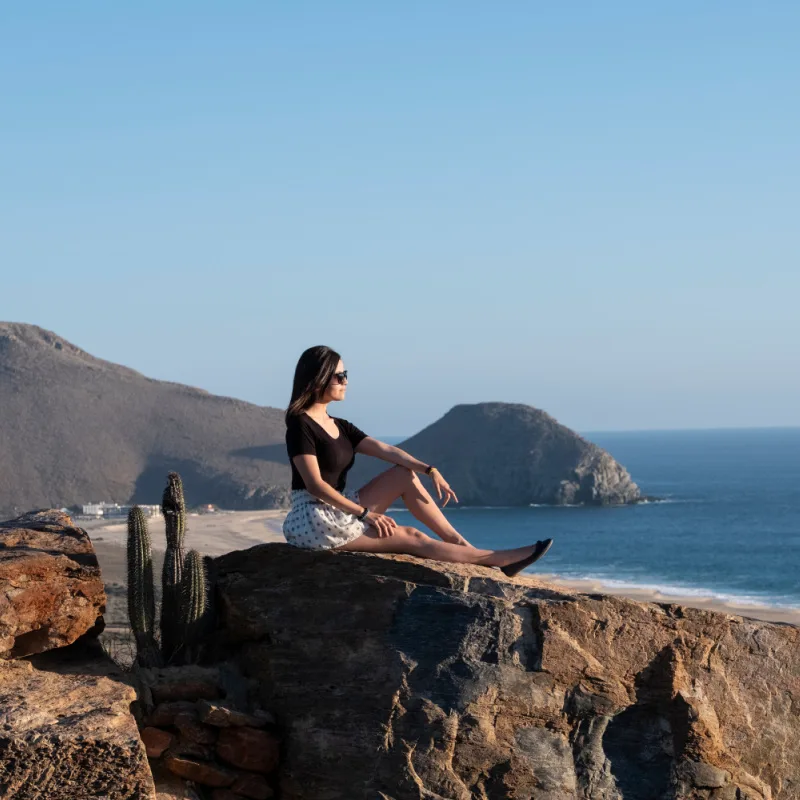 girl sitting on rock