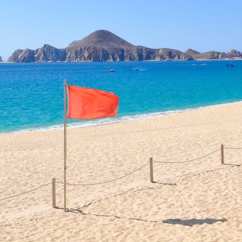 Red flag posted on a beach in Los Cabos